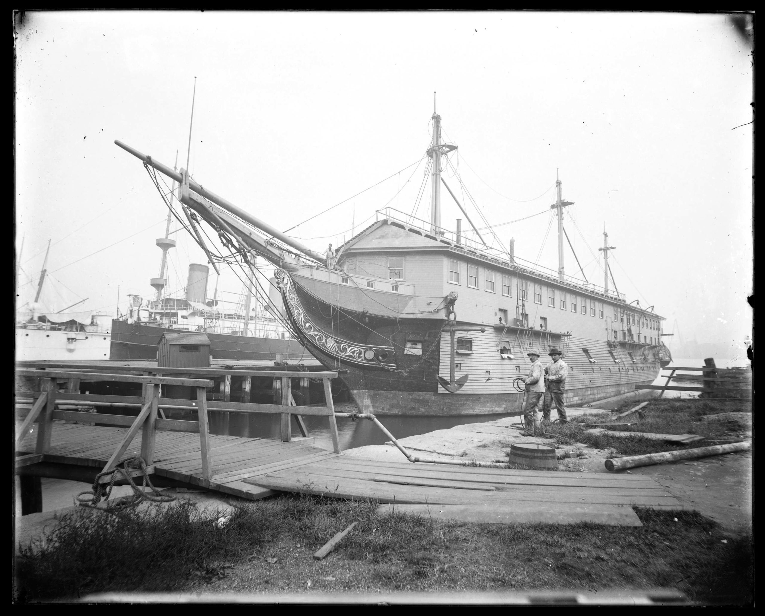 Photographic print, produced from a glass plate negative, showing USS Constitution docked in Boston around 1900. [Commodores Fund Purchase]